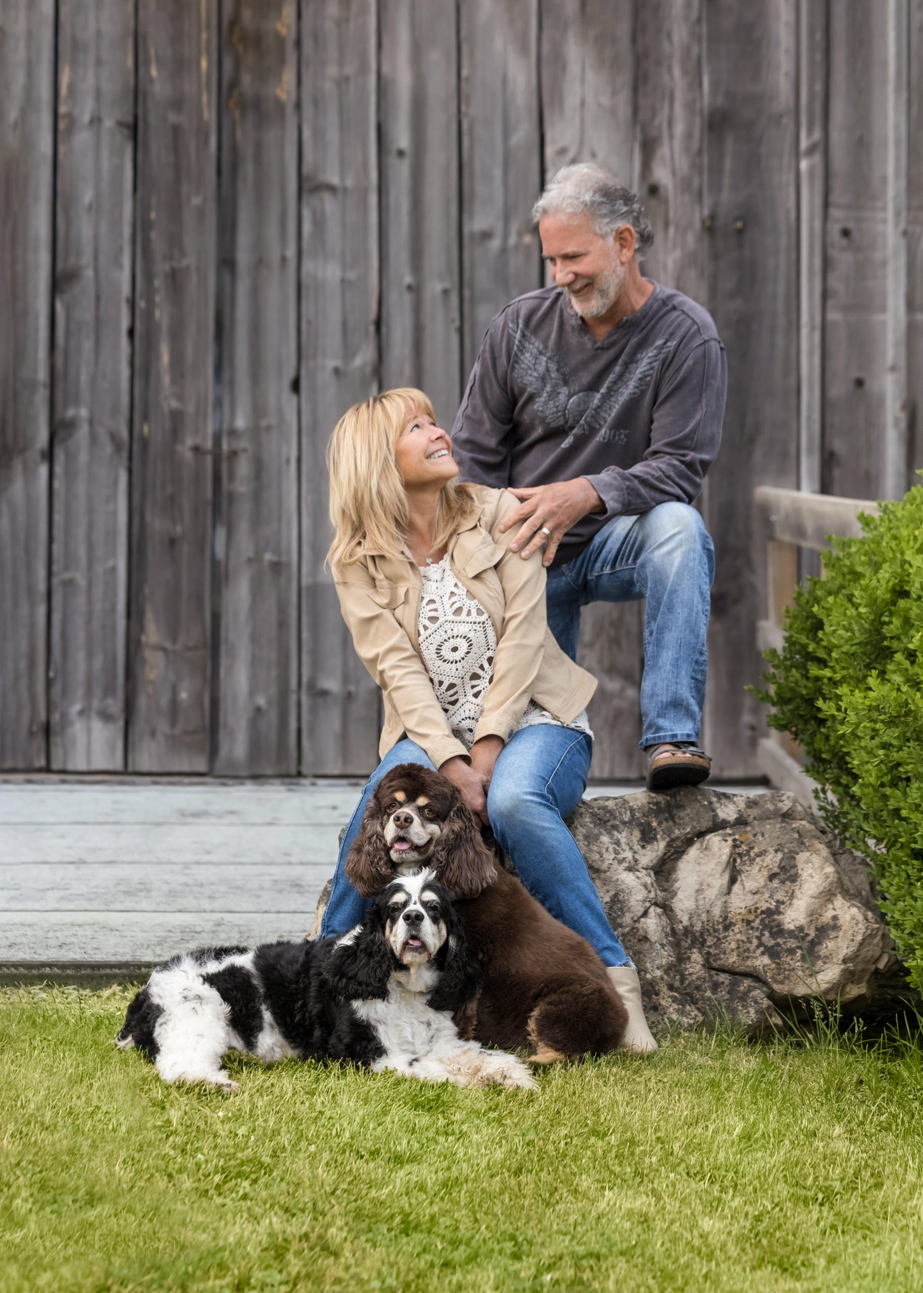 family portrait of couple and their two senior cockapoos at cave spring winery