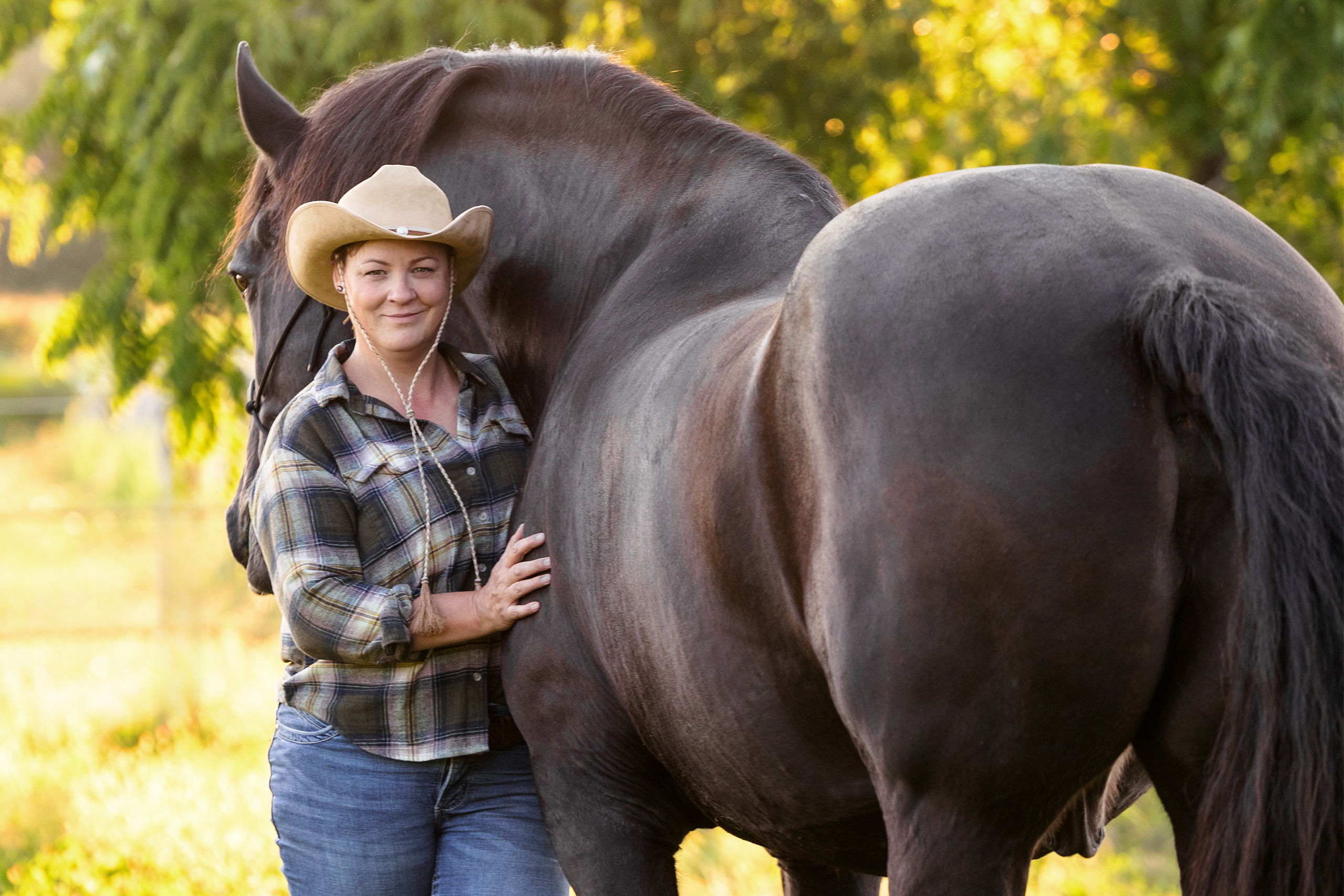 woman and her draft horse backlit on St Anns farm in niagara