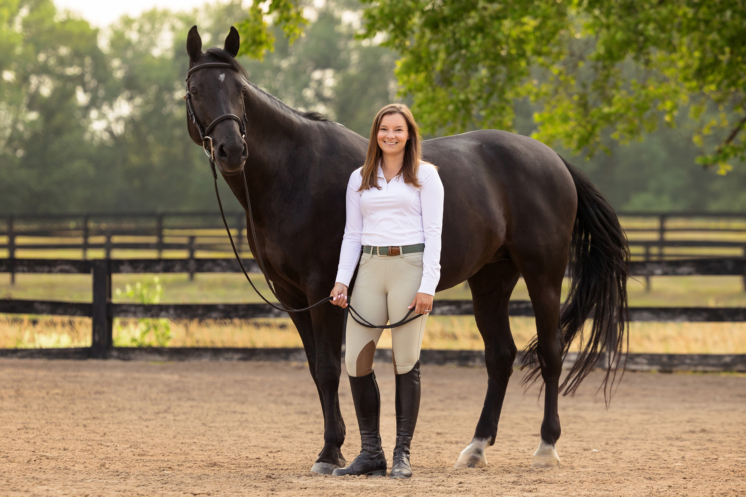 equestrian and her horse in outdoor arena