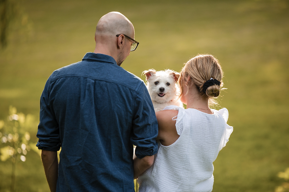 woman and her frenchie lying in grass in Jordan ontario canoodling